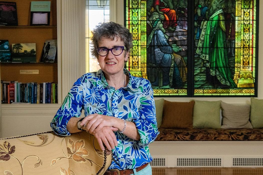 Patricia Palmer in front of a stained glass window